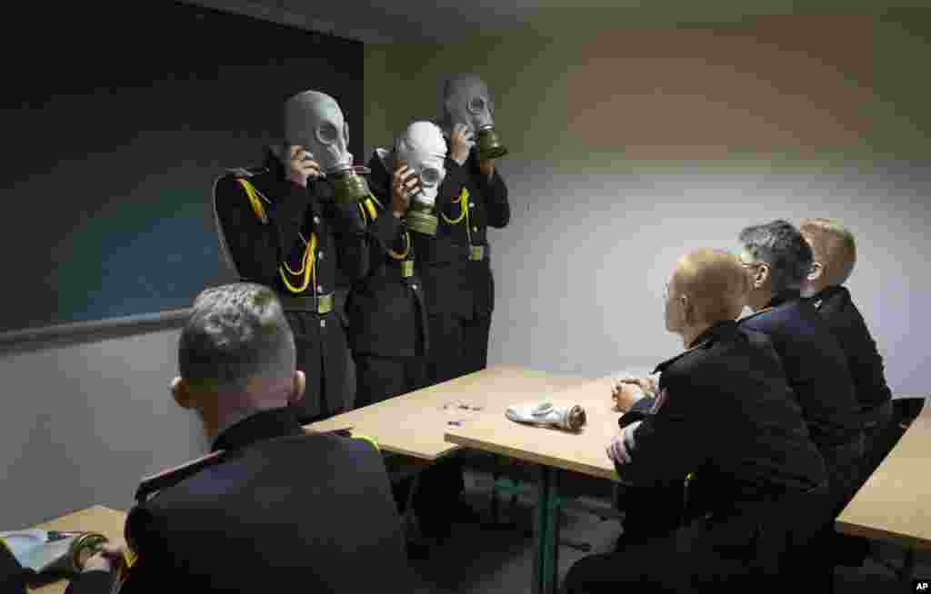 Cadets practice an emergency situation during a lesson in a bomb shelter on the first day of school at a cadet lyceum in Kyiv, Ukraine, Sept. 1, 2022. (AP Photo/Efrem Lukatsky)APTOPIX Ukraine School Cadets