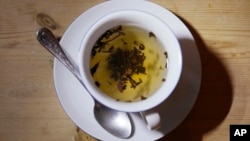 This photo shows a cup of black tea with a spoon and tea leaves in London, Monday, Aug. 29, 2022. (AP Photo/Alastair Grant)