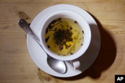 This photo shows a cup of black tea with a spoon and tea leaves in London, Monday, Aug. 29, 2022. (AP Photo/Alastair Grant)