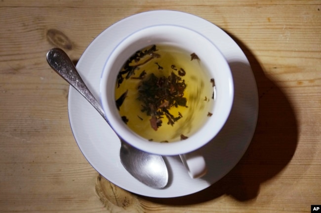 This photo shows a cup of black tea with a spoon and tea leaves in London, Monday, Aug. 29, 2022. (AP Photo/Alastair Grant)