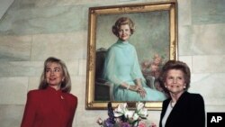 FILE - Then-first lady Hillary Rodham Clinton poses with former first lady Betty Ford under Ford's White House portrait in Washington, March 2, 1993.