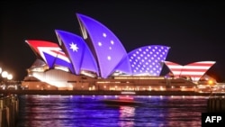 The flags of the US and Australia are projected onto the sails of the Opera House to commemorate the 70th anniversary of the alliance between Australia, New Zealand and the US known as the ANZUS Treaty in Sydney on Sept. 1, 2021. 