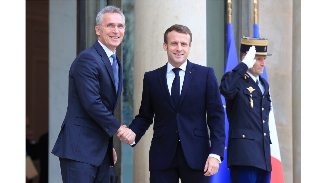 NATO Secretary General Jens Stoltenberg, left, is welcomed by French President Emmanuel Macron at the Elysee Palace in Paris, Nov. 28, 2019.
