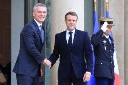 NATO Secretary General Jens Stoltenberg, left, is welcomed by French President Emmanuel Macron at the Elysee Palace in Paris, Nov. 28, 2019.