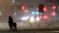 A woman and a child cross a snow-covered street during a snowstorm, Wednesday, March 21, 2018, in Jersey City, N.J.