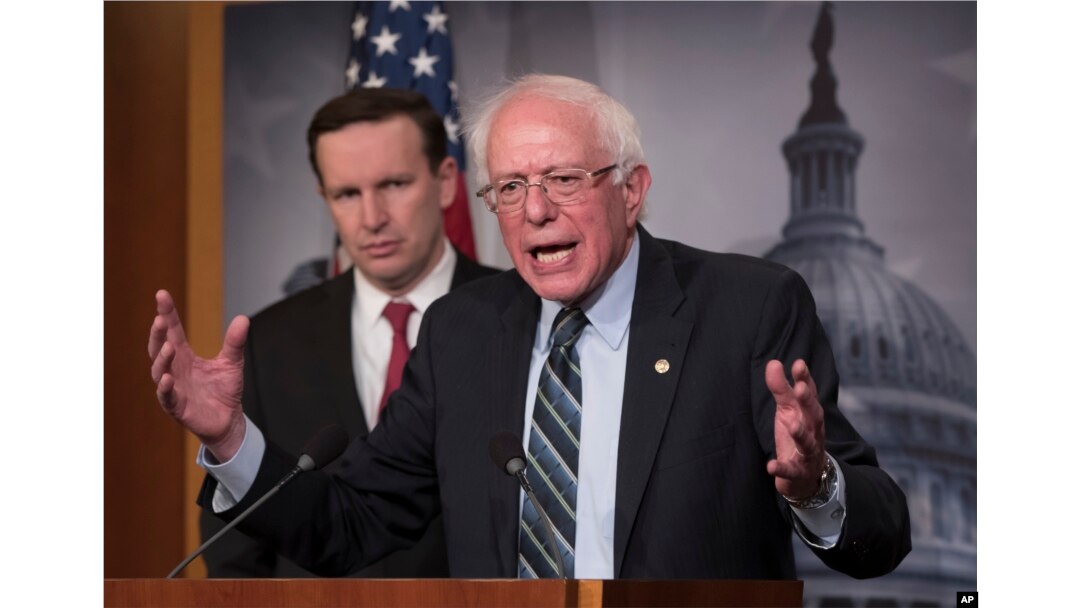 Sen. Bernie Sanders, I-Vt., joined at left by Sen. Chris Murphy, D-Conn., holds a news conference after the Senate passed a resolution he introduced that would pull assistance from the Saudi-led war in Yemen, a measure to rebuke Saudi Arabia after the killing of journalist Jamal Khashoggi, at the Capitol in Washington, Dec. 13, 2018.
