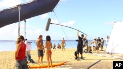 "Hawaii Five-0" stars Scott Caan and Grace Park film on location on the beach.