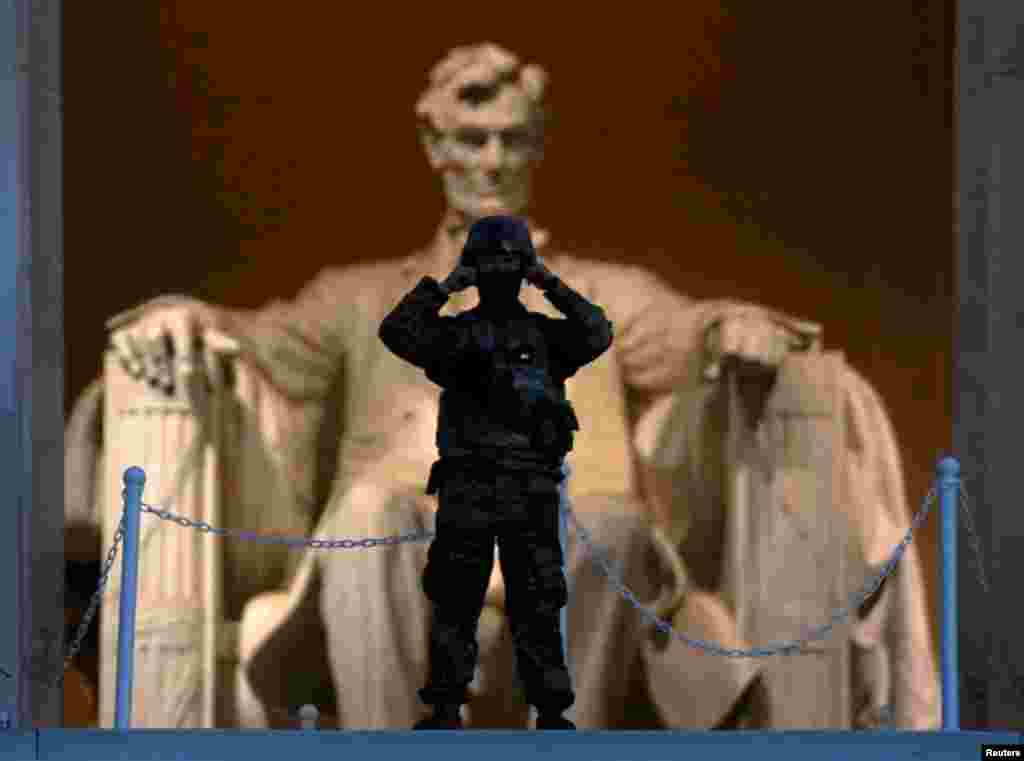 At sunrise, a soldier keeps watch at the Lincoln Memorial in Washington after a night of protests over the death in Minneapolis police custody of George Floyd.