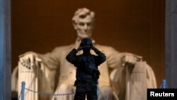 At sunrise, a soldier keeps watch at the Lincoln Memorial in Washington, D.C., after a night of protests over the death of George Floyd, an African American man who died May 25 after being restrained by police in Minneapolis..