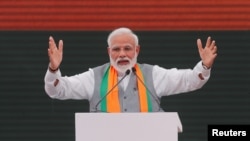 FILE - Indian Prime Minister Narendra Modi gestures as he speaks in New Delhi, April 8, 2019. Press freedom watchdogs accused the Indian government of retaliating against a British writer for criticizing Modi in Time Magazine.