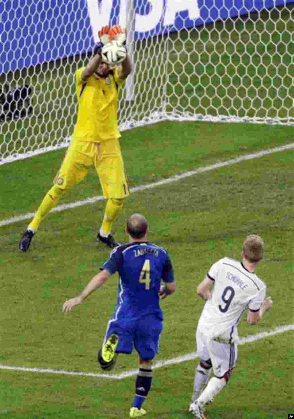 Argentina's goalkeeper Sergio Romero saves a shot by Germany's Andre Schuerrle during the extra time of the World Cup final soccer match between Germany and Argentina at the Maracana Stadium in Rio de Janeiro, Brazil, Sunday, July 13, 2014. (AP Photo/The