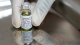 In this file image, a pharmacist holds a vial of lenacapavir, the new HIV prevention injectable drug, at a health research center in Cape Town, South Africa, Tuesday, July 23, 2024. (AP Photo/Nardus Engelbrecht, File)