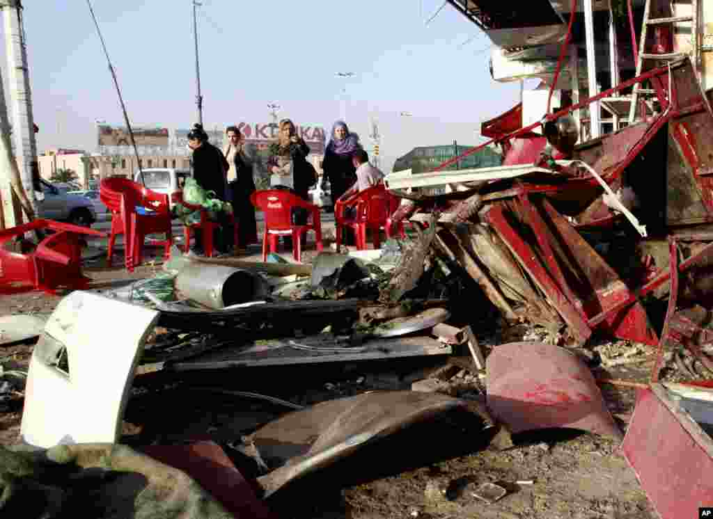 People at the site of a car bomb attack in Karrada, Baghdad, Sept. 4, 2013.