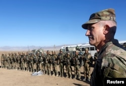 FILE - U.S. Army General John Nicholson, commander of Resolute Support forces and U.S. forces in Afghanistan, speaks with Afghan police special forces after they took part in a military exercise in Logar province, Afghanistan, Nov. 30, 2017.