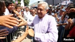 Leftist front-runner Andres Manuel Lopez Obrador of the National Regeneration Movement (MORENA) is greeted by supporters after a campaign rally in Tlapa de Comonfort, in Guerrero state, Mexico, June 7, 2018. 