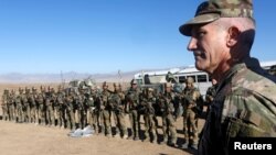 FILE - U.S. Army General John Nicholson, commander of Resolute Support forces and U.S. forces in Afghanistan, speaks with Afghan police special forces after they took part in a military exercise in Logar province, Afghanistan, Nov. 30, 2017.