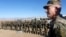 FILE - U.S. Army General John Nicholson, commander of Resolute Support forces and U.S. forces in Afghanistan, speaks with Afghan police special forces after they took part in a military exercise in Logar province, Afghanistan, Nov. 30, 2017.