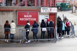 People queue for COVID-19 testing at a mass screening centre at Charlton Athletic Football Club as the spread of the coronavirus disease (COVID-19) continues in London, Britain, Jan. 3, 2021.