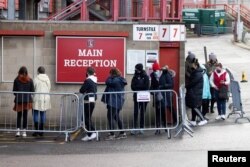 People queue for COVID-19 testing at a mass screening centre at Charlton Athletic Football Club as the spread of the coronavirus disease (COVID-19) continues in London, Britain, Jan. 3, 2021.
