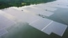 FILE - This undated handout photograph released by Singapore's national water agency PUB on July 14, 2021 shows an aerial view of Sembcorb energy company's new floating solar power farm at Tengeh reservoir in Singapore. 