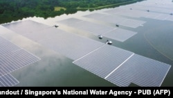 FILE - This undated handout photograph released by Singapore's national water agency PUB on July 14, 2021 shows an aerial view of Sembcorb energy company's new floating solar power farm at Tengeh reservoir in Singapore. 