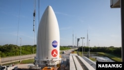The payload fairing, or nose cone, containing the Mars 2020 Perseverance rover sits atop the motorized payload transporter that will carry it to Space Launch Complex 41 on Cape Canaveral Air Force Station in Florida, July 7, 2020.(Credit: NASA/KSC)