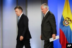 Colombia's President Juan Manuel Santos, left, and U.S. Secretary of State Rex Tillerson walk away after a press conference at the presidential palace in Bogota, Colombia, Tuesday, Feb. 6, 2018.