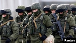 Những người mặc đồng phục được tin là binh sĩ của Nga dàn quân gần một căn cứ của Ukraina ở làng Perevalnoye bên ngoài Simferopol, 6/3/2014