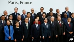 FILE - French President Francois Hollande, front center, poses with world leaders for a group photo as part of the COP21, United Nations Climate Change Conference, in Le Bourget, outside Paris, Nov. 30, 2015.
