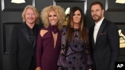 FILE - Philip Sweet, from left, Kimberly Schlapman, Karen Fairchild, and Jimi Westbrook of the musical group Little Big Town attend the 59th annual Grammy Awards in Los Angeles, Feb. 12, 2017.