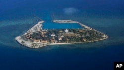 FILE - The Vietnamese-claimed Southwest Cay island in the Spratly island group is seen from a Philippine Air Force C-130 transport plane.