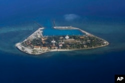 FILE - The Vietnamese-claimed Southwest Cay island in the Spratly island group is seen from a Philippine Air Force C-130 transport plane.