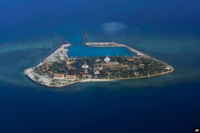 FILE - The Vietnamese-claimed Southwest Cay island in the Spratly island group is seen from a Philippine Air Force C-130 transport plane.
