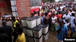 People wait to vote during the presidential election at a polling station in Monrovia, Liberia, Oct. 10, 2017. 