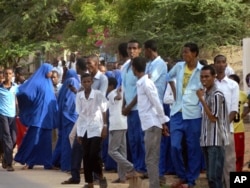 FILE - Students gather and watch from a distance outside the Garissa University College after an attack by gunmen, in Garissa, Kenya, Thursday, April 2, 2015. Gunmen attacked the university early Thursday, shooting indiscriminately in campus hostels. Police and