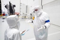 FILE - Principal Investigator for NASA's Lucy spacecraft, Hal Levison, right, speaks with a reporter at the AstroTech facility, in Titusville, Fla., Sept. 29, 2021.
