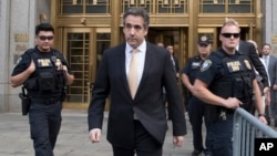 Michael Cohen leaves Federal court, Tuesday, Aug. 21, 2018, in New York.Cohen, has pleaded guilty to charges including campaign finance fraud stemming from hush money payments to porn actress Stormy Daniels and ex-Playboy model Karen McDougal. (AP Photo/Mary Altaffer)