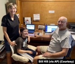 Mary and Bill Hill are pictured with their 8-year-old grandson Will in suburban Phoenix, Arizona. They oversee his distance learning. (Bill Hill via AP)