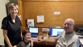 Mary and Bill Hill are pictured with their 8-year-old grandson Will in suburban Phoenix, Arizona. They oversee his distance learning. (Bill Hill via AP)
