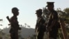 FILE - Three soldiers patrol along a mountain near Laiza, Kachin State, Myanmar, Nov. 30, 2016.