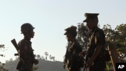 FILE - Three soldiers patrol along a mountain near Laiza, Kachin State, Myanmar, Nov. 30, 2016.