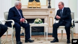 Russian President Vladimir Putin, right, speaks to Palestinian President Mahmoud Abbas, during their meeting in the Kremlin in Moscow, Feb. 12, 2018.