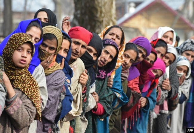 Kashmiri villagers look on during the funeral of militant commander Noor Mohammad Tantray in the Aripal village of Tral district on December 26, 2017.