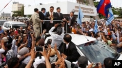 Sam Rainsy, leader of the opposition Cambodia National Rescue Party (CNRP) greets supporters in Phnom Penh, Cambodia, Saturday, July 19, 2014. 