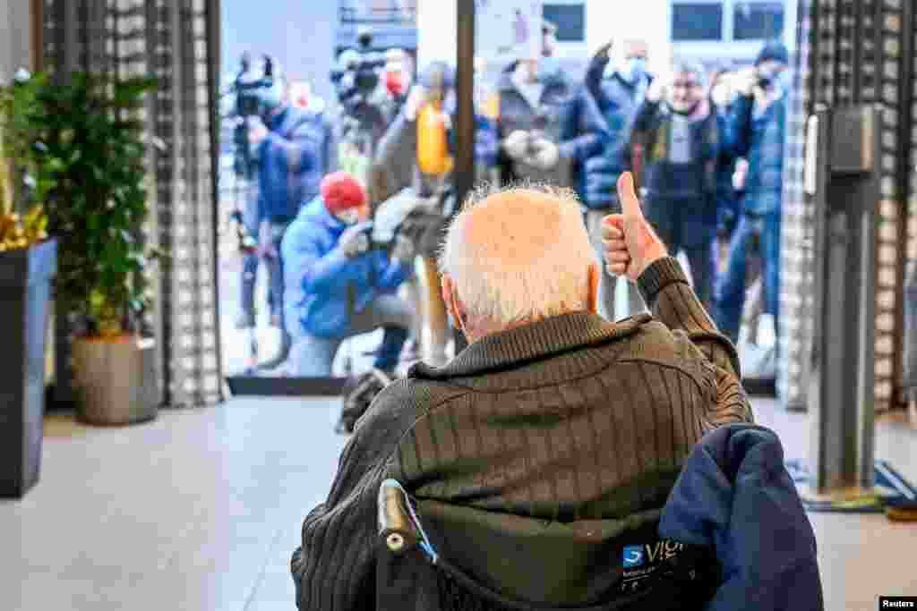 Jos Hermans, 96, who received a Pfizer/BioNtech COVID-19 vaccine, gives a thumb up at Woonzorgcentrum Sint-Pieters in Puurs-Sint-Amands, Belgium.