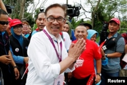 FILE - Malaysia's politician Anwar Ibrahim visits a polling station during the by-election in Port Dickson, Malaysia, Oct. 13, 2018.