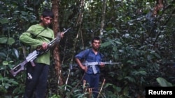 FILE - Members of Peru's Shining Path terrorist group, speak to journalists in a remote jungle region in southern Peru, Cuzco, April 17, 2012.