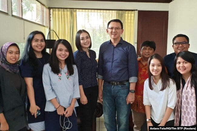 Former Jakarta Gov. Basuki "Ahok" Tjahaja Purnama poses with his relatives after being released from prison in Jakarta, Indonesia, Jan. 24, 2019.