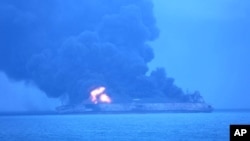 In this photo provided by Korea Coast Guard, the Panama-registered tanker "Sanchi" is seen ablaze after a collision with a Hong Kong-registered freighter off China's eastern coast, Jan. 7, 2018. 