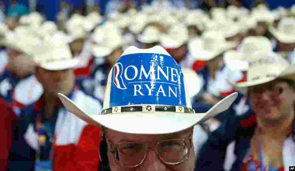 Texas delegate Clint Moore and the rest of Texas delegates fashion their cowboy hats on the floor.